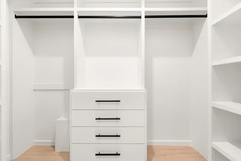 a bedroom with a bed and a potted plant