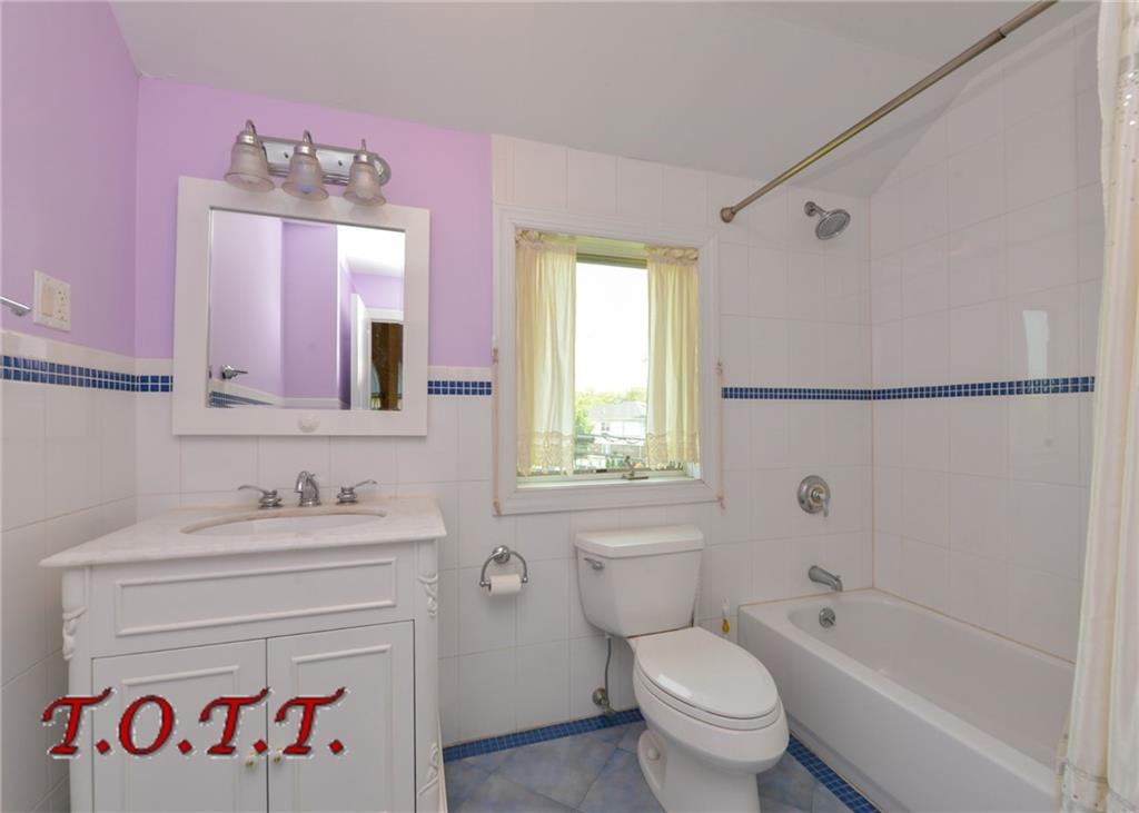 11 Bell Point Drive Brooklyn, NY 11234 - Photo 11 of 30 a bathroom with a sink a toilet and a bathtub