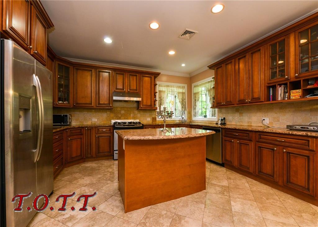 11 Bell Point Drive Brooklyn, NY 11234 - Photo 16 of 30 a kitchen with stainless steel appliances granite countertop a stove top oven a refrigerator a sink and dishwasher