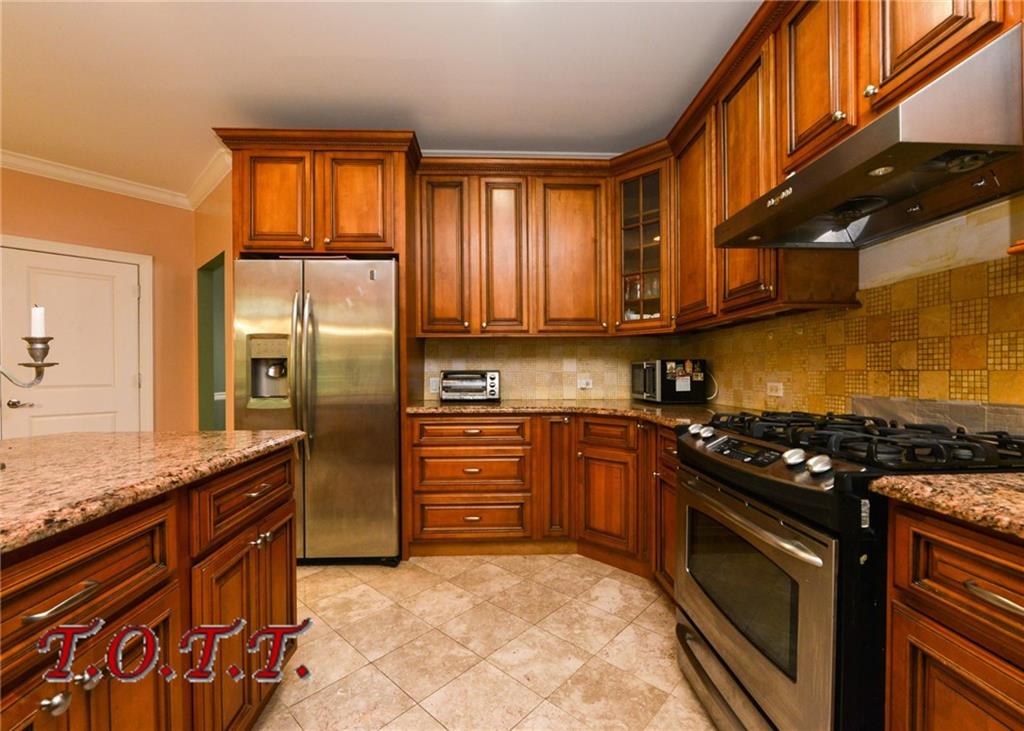 11 Bell Point Drive Brooklyn, NY 11234 - Photo 19 of 30 a kitchen with granite countertop stainless steel appliances and wooden cabinets