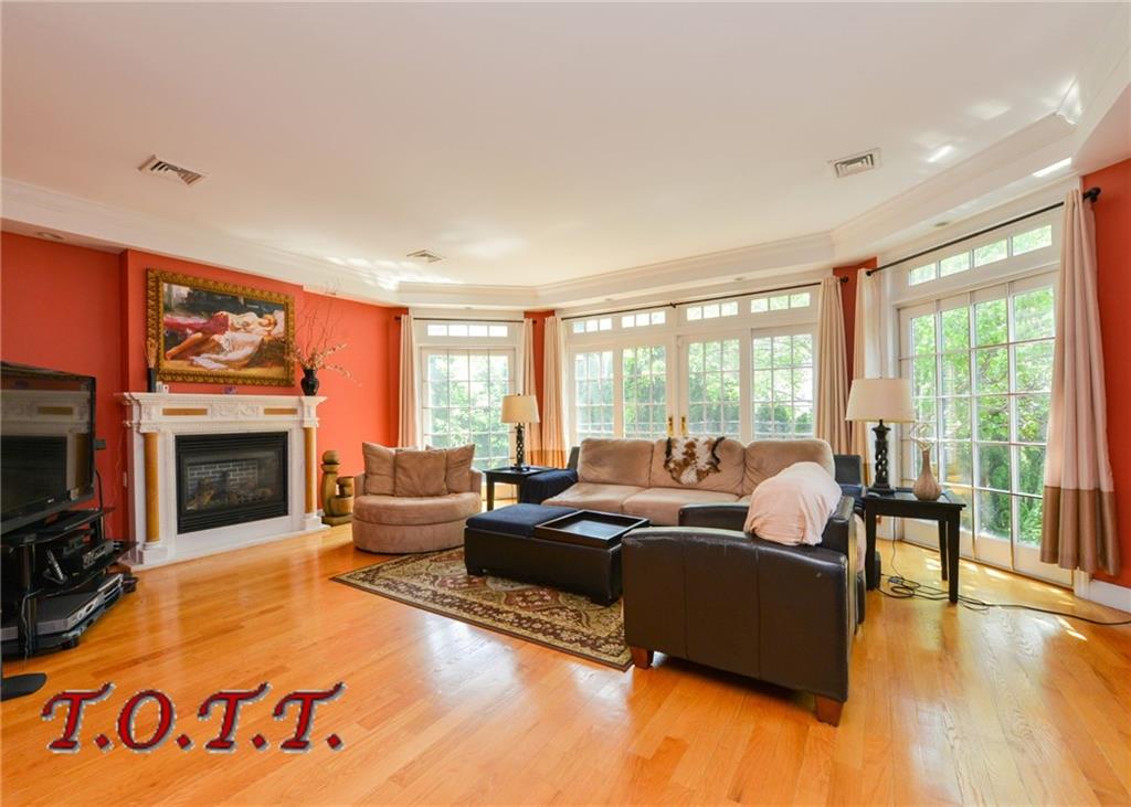 11 Bell Point Drive Brooklyn, NY 11234 - Photo 20 of 30 a living room with furniture large window and a fireplace