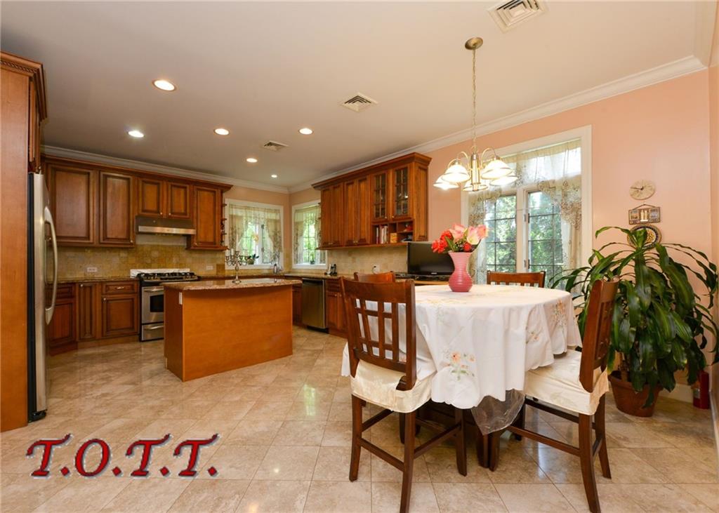 11 Bell Point Drive Brooklyn, NY 11234 - Photo 21 of 30 a open kitchen with kitchen island a large window cabinets and stainless steel appliances