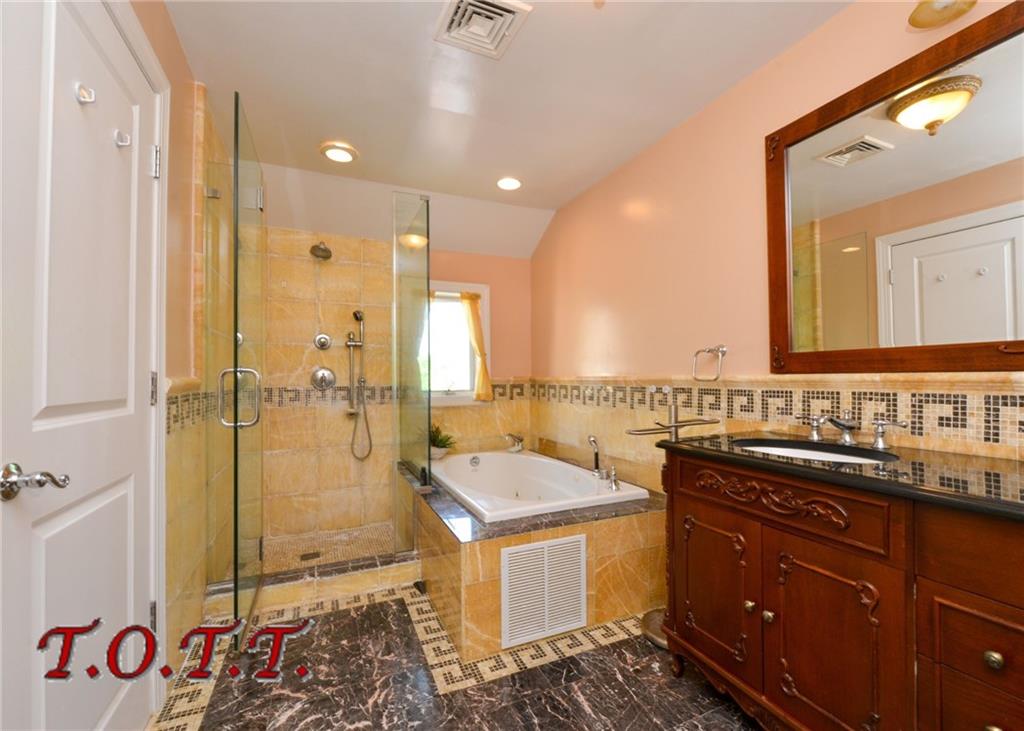 11 Bell Point Drive Brooklyn, NY 11234 - Photo 3 of 30 a bathroom with a tub sink mirror vanity and toilet