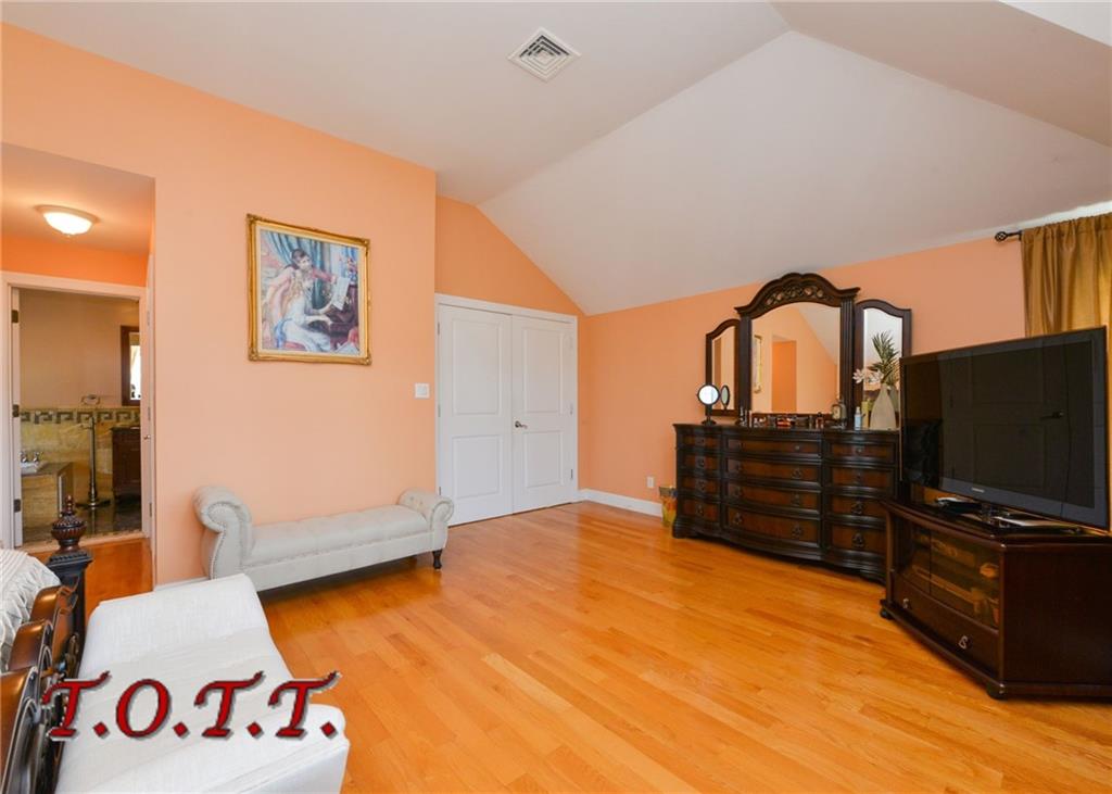 11 Bell Point Drive Brooklyn, NY 11234 - Photo 4 of 30 a bedroom with a bed and a flat screen tv