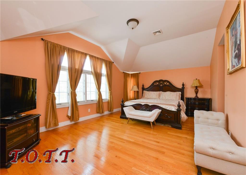 11 Bell Point Drive Brooklyn, NY 11234 - Photo 6 of 30 a bedroom with furniture and a flat screen tv