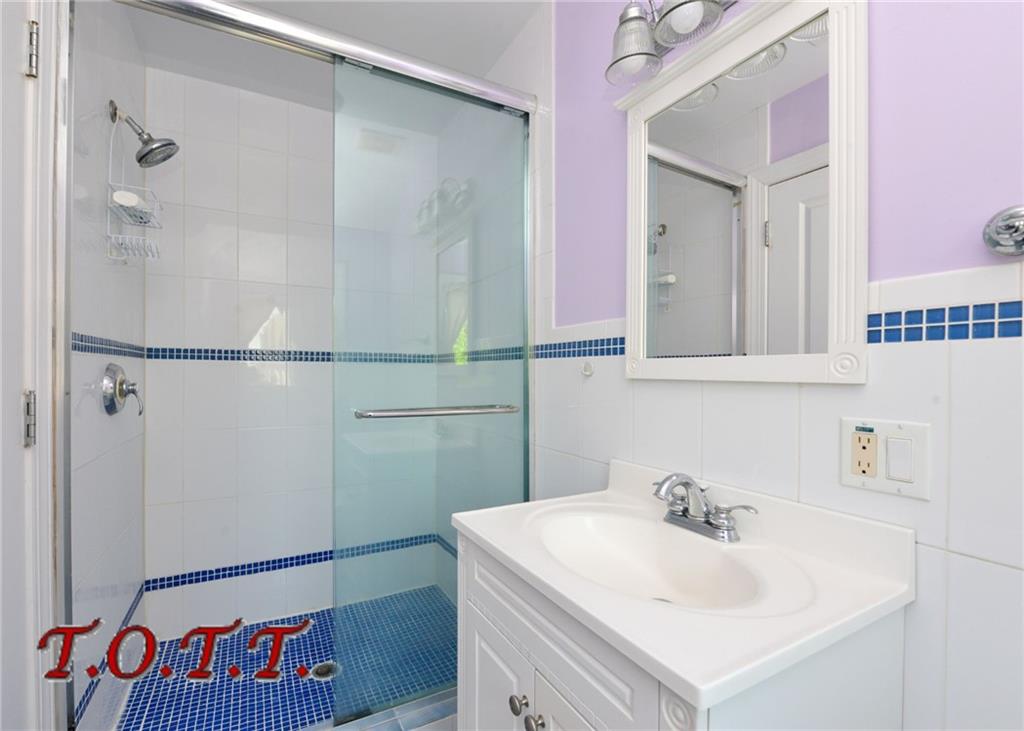 11 Bell Point Drive Brooklyn, NY 11234 - Photo 7 of 30 a bathroom with a sink and a mirror