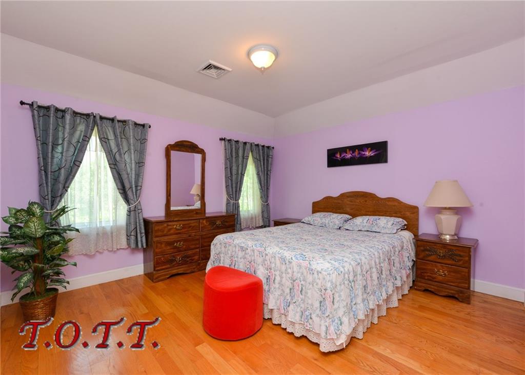 11 Bell Point Drive Brooklyn, NY 11234 - Photo 9 of 30 a bedroom with a bed and a potted plant