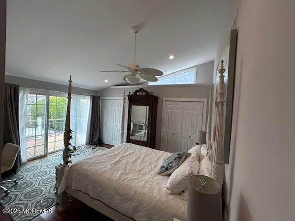 a bed room with a bed mirror and a window