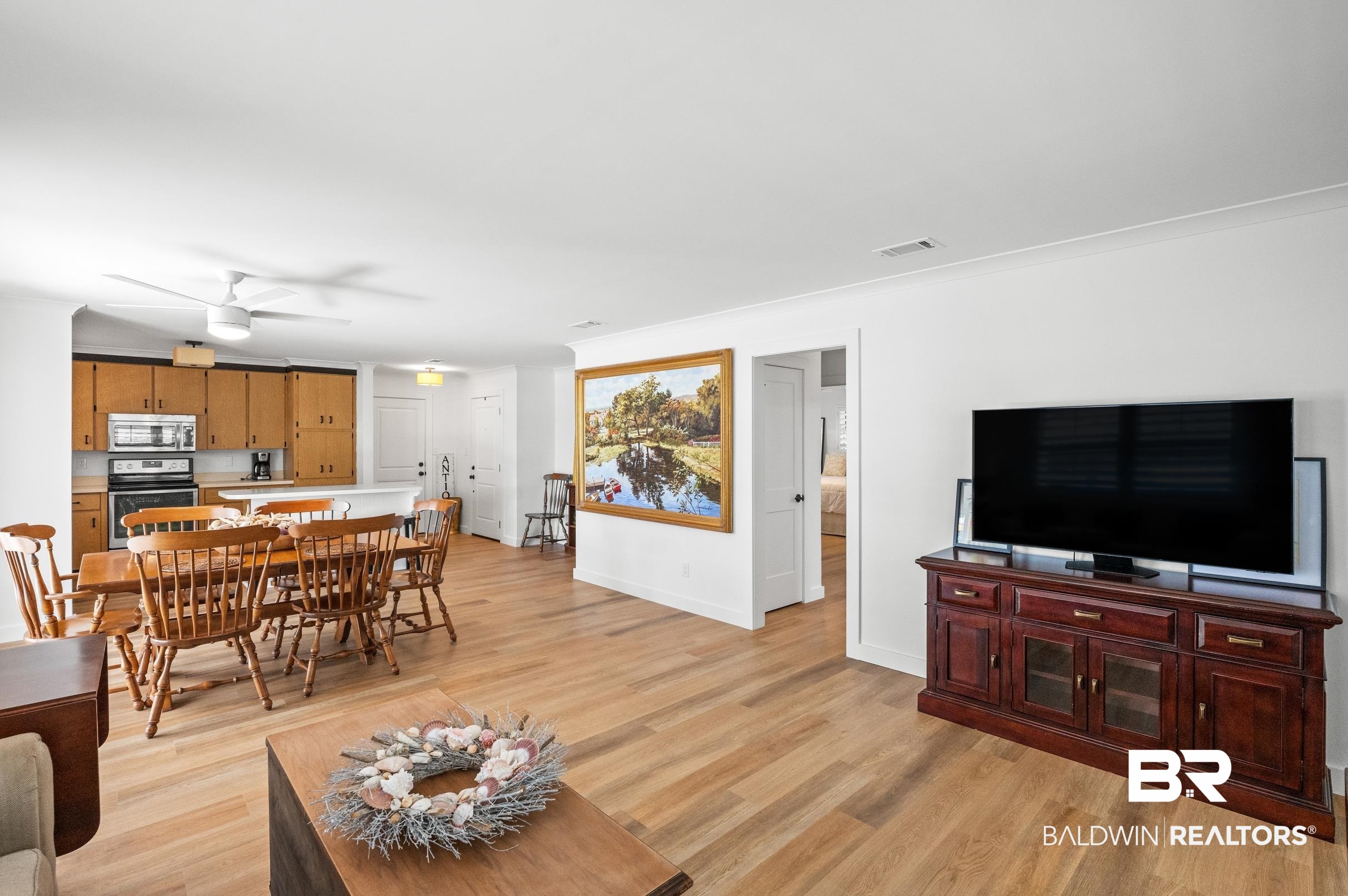 9459 Soldier Creek Road Lillian, AL 36549 - Photo 14 of 54 Living area featuring light wood finished floors, ceiling fan, visible vents, and baseboards