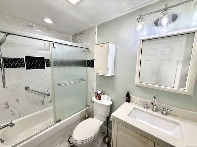 a bathroom with a sink toilet and shower