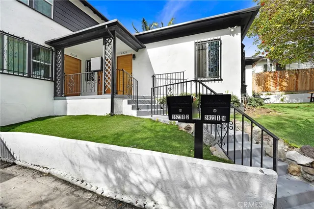 a view of a house with backyard and porch