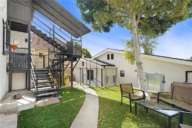 a backyard of a house with table and chairs