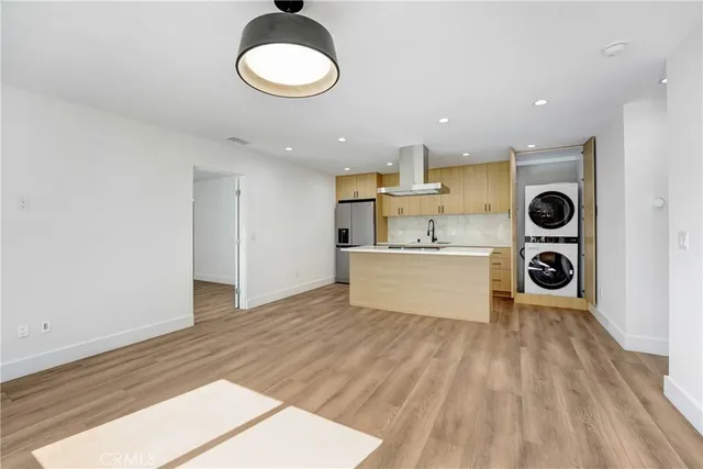 a view of kitchen with stainless steel appliances cabinets and wooden floor