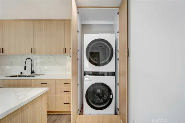 a utility room with sink dryer and washer