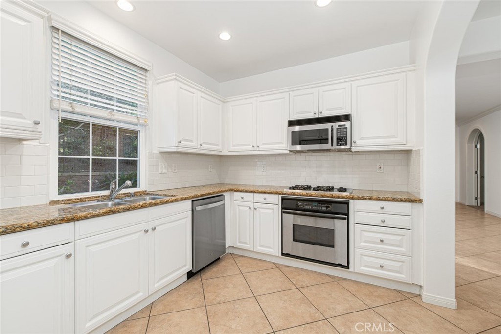 72 Clouds View Irvine, CA 92603 - Photo 14 of 43 a kitchen with granite countertop cabinets stainless steel appliances and a sink