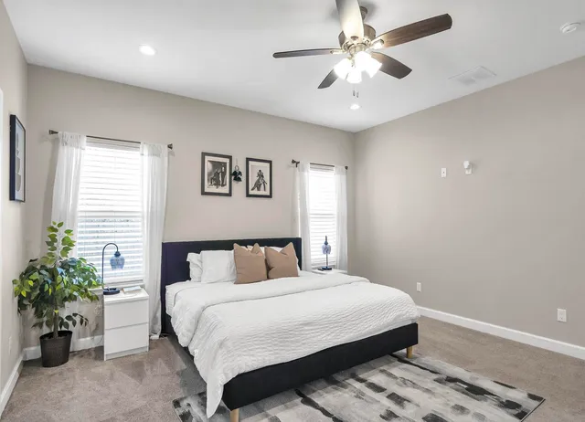 a bedroom with a bed and a chandelier