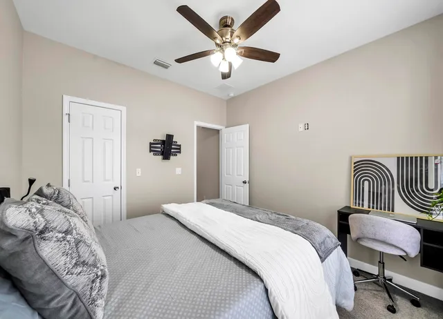 a bedroom with a bed and a chandelier