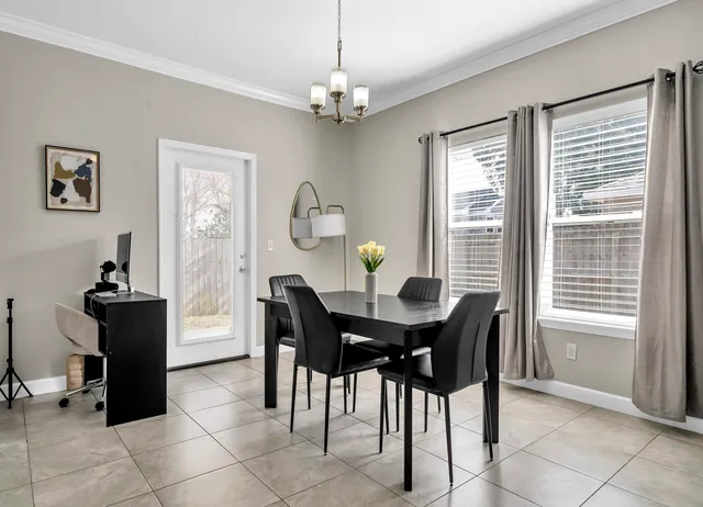a view of a dining room with furniture and chandelier