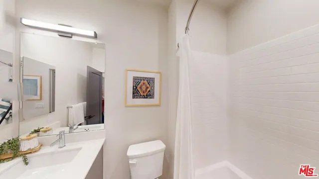 a bathroom with a sink toilet and vanity