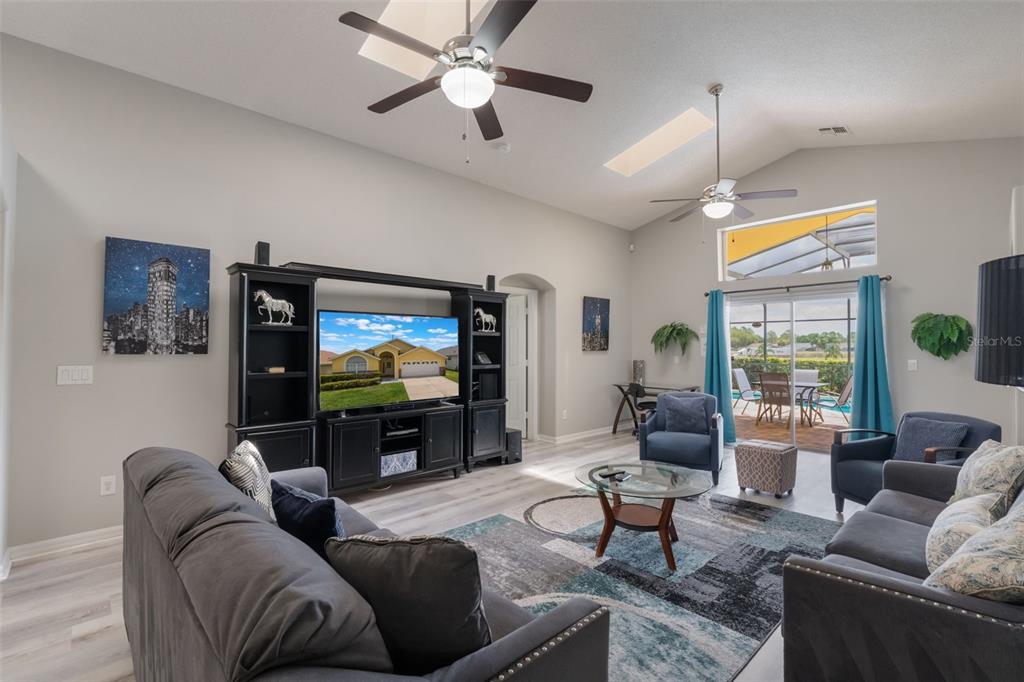 2685 Oneida Loop Kissimmee, FL 34747 - Photo 11 of 54 a living room with furniture and a flat screen tv