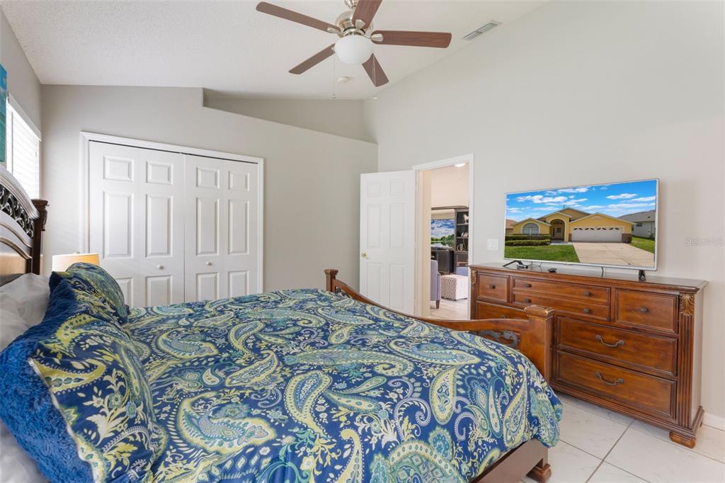 2685 Oneida Loop Kissimmee, FL 34747 - Photo 16 of 54 a bedroom with a bed and a flat screen tv