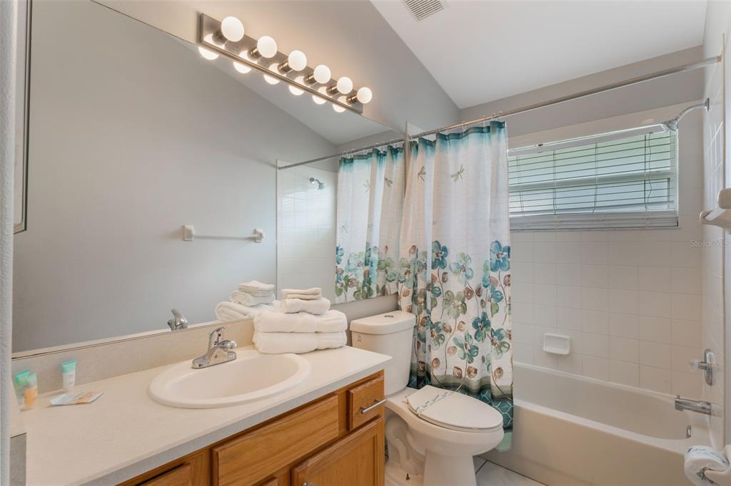 2685 Oneida Loop Kissimmee, FL 34747 - Photo 17 of 54 a bathroom with a sink toilet and shower