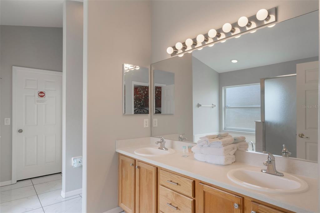 2685 Oneida Loop Kissimmee, FL 34747 - Photo 20 of 54 a bathroom with a sink double vanity and a mirror
