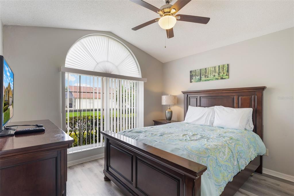 2685 Oneida Loop Kissimmee, FL 34747 - Photo 25 of 54 a bedroom with a bed and a chandelier