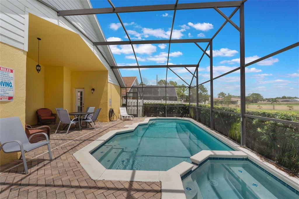 2685 Oneida Loop Kissimmee, FL 34747 - Photo 30 of 54 a swimming pool with lawn chairs and painted walls