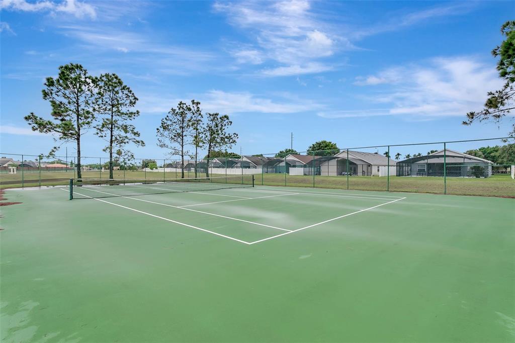 2685 Oneida Loop Kissimmee, FL 34747 - Photo 44 of 54 a view of a tennis ground with large trees
