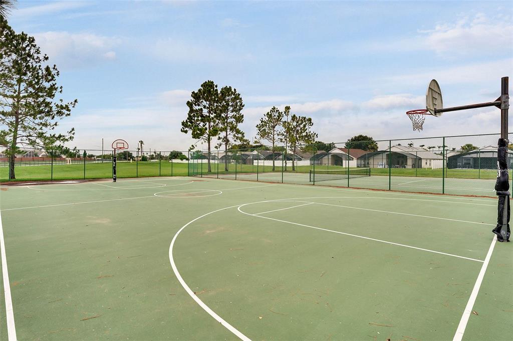 2685 Oneida Loop Kissimmee, FL 34747 - Photo 54 of 54 a view of a tennis ground with large trees