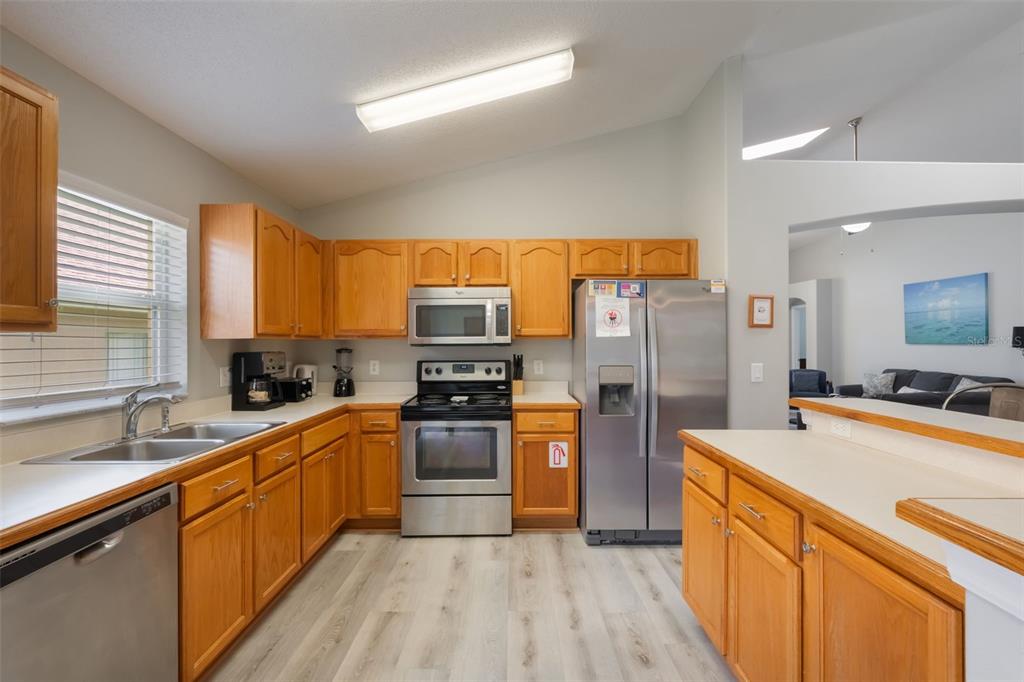 2685 Oneida Loop Kissimmee, FL 34747 - Photo 6 of 54 a kitchen with stainless steel appliances a refrigerator sink and microwave