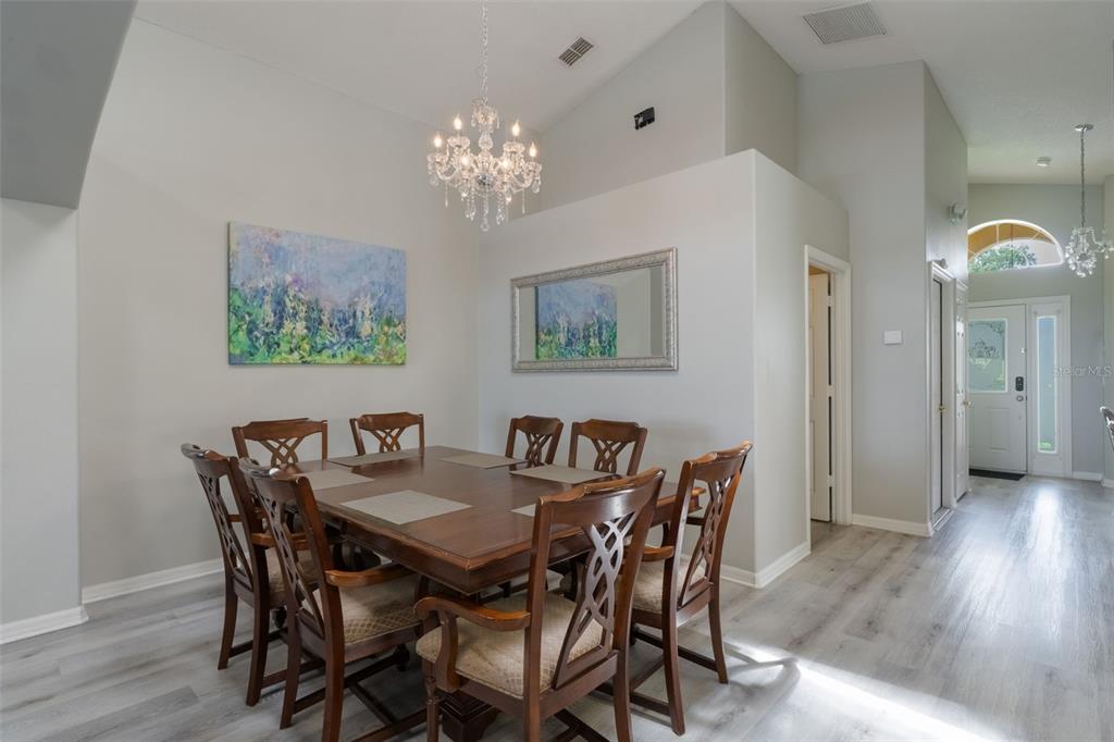 2685 Oneida Loop Kissimmee, FL 34747 - Photo 8 of 54 a view of a dining room with furniture and wooden floor