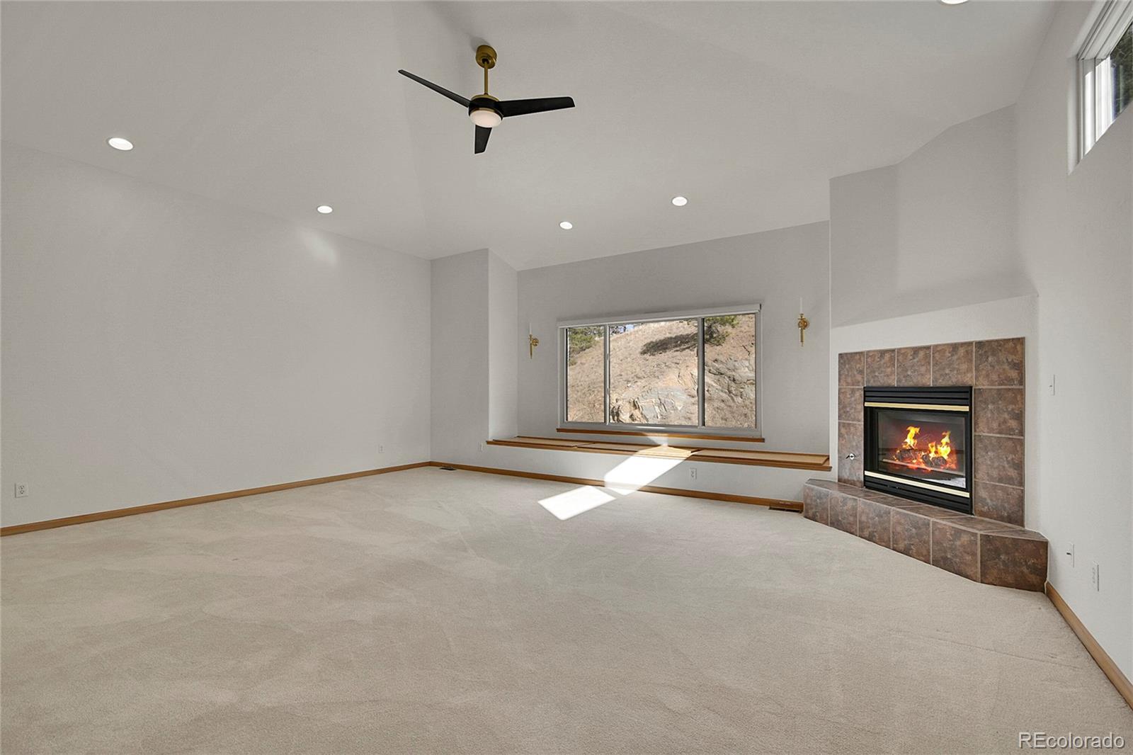671 Trailside Drive Golden, CO 80401 - Photo 19 of 39 an empty room with windows and fireplace