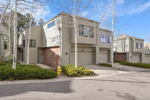 a view of a door of the house with a door and wooden bench