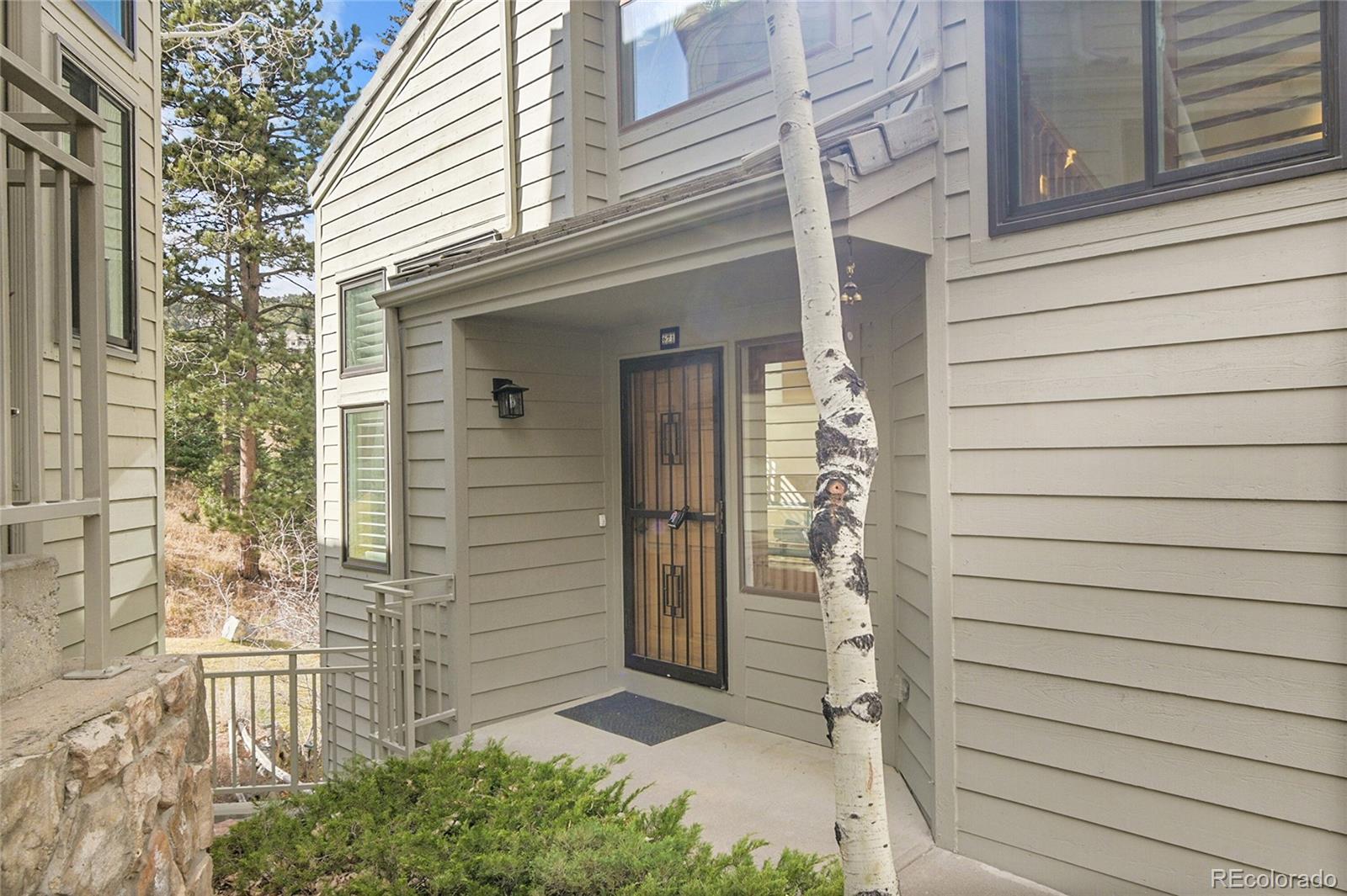 671 Trailside Drive Golden, CO 80401 - Photo 4 of 39 a view of a door of the house with a door and wooden bench
