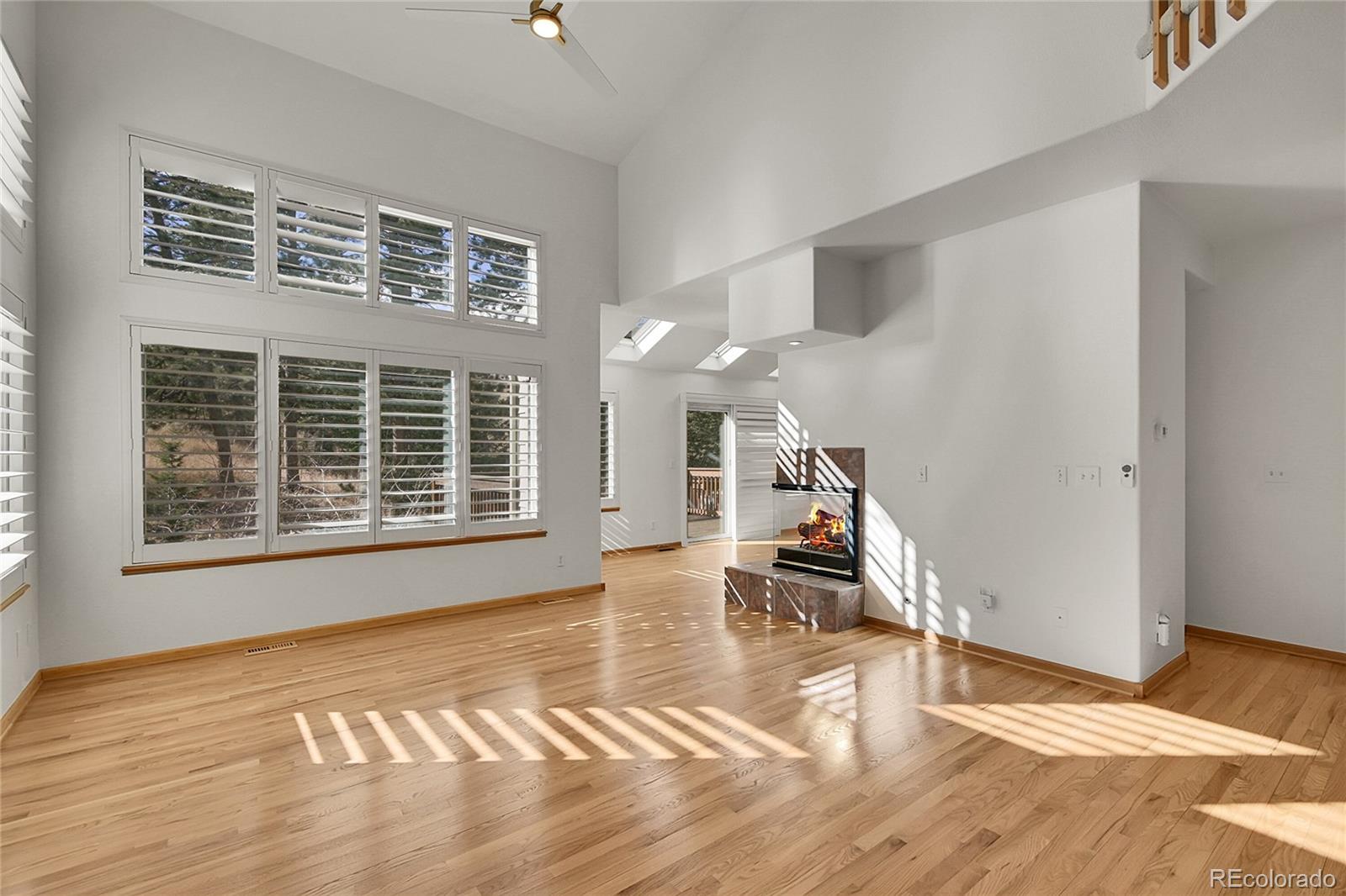 671 Trailside Drive Golden, CO 80401 - Photo 5 of 39 a view of empty room with wooden floor and fan