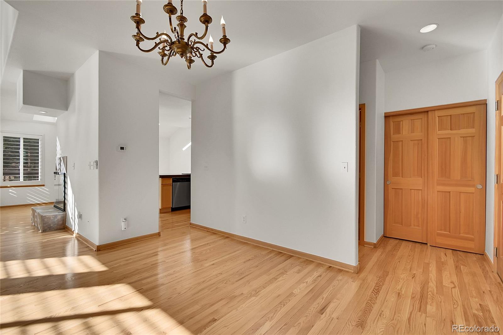 671 Trailside Drive Golden, CO 80401 - Photo 9 of 39 a view of an empty room with wooden floor