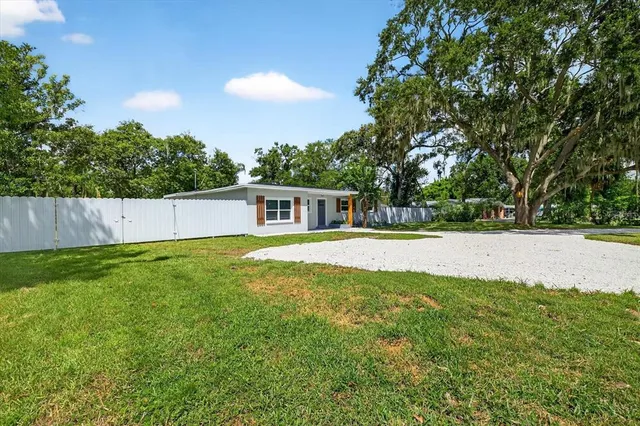 a view of kitchen with wooden floor and electronic appliances