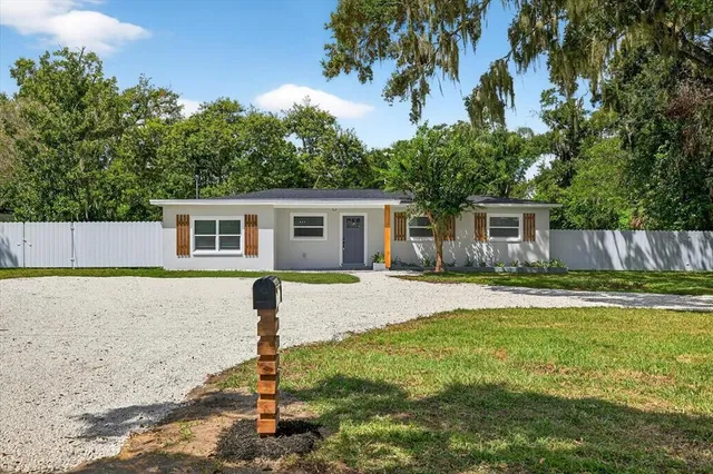 a kitchen with kitchen island a counter space a sink stainless steel appliances and windows