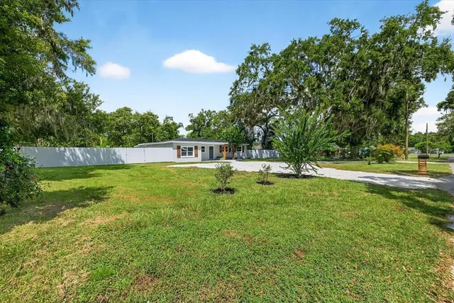 a kitchen with a sink stove top oven and cabinets