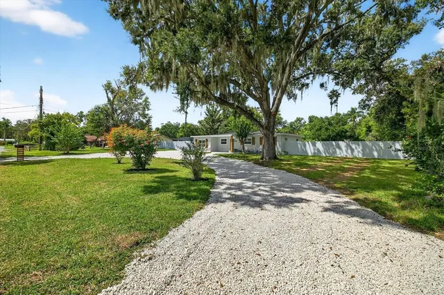 a large kitchen with a large counter top appliances and cabinets