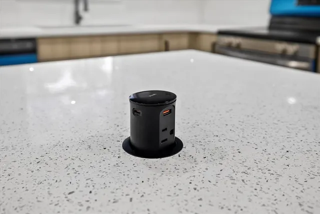 a view of a room with wooden floor and a ceiling fan