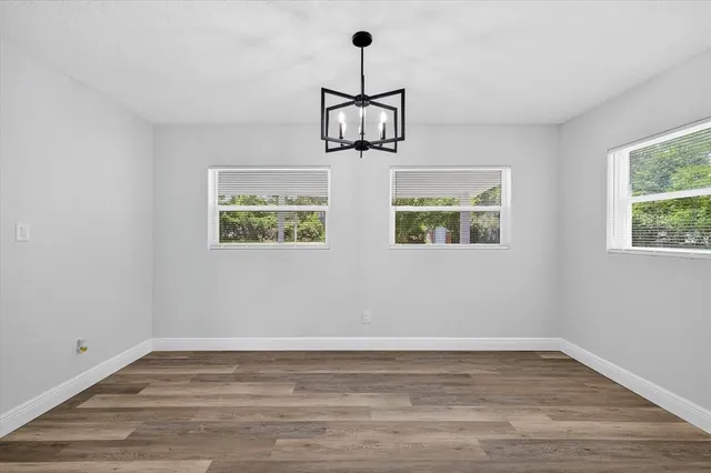 a view of a house with backyard and a tree