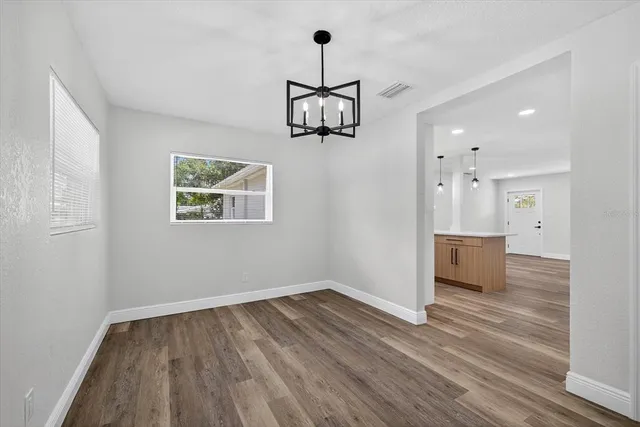 a view of a grassy field with trees in the background