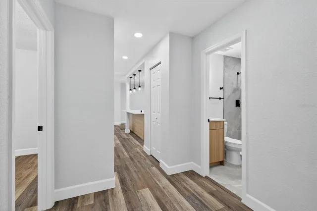 an aerial view of a house with a yard and large trees