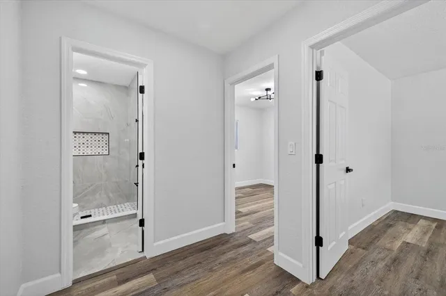 an aerial view of residential house with outdoor space and trees all around