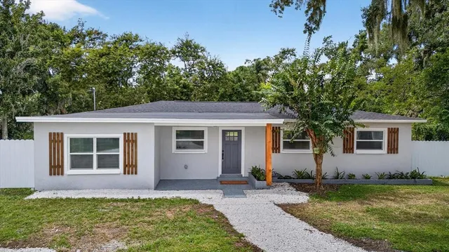 a house view with swimming pool in front of it
