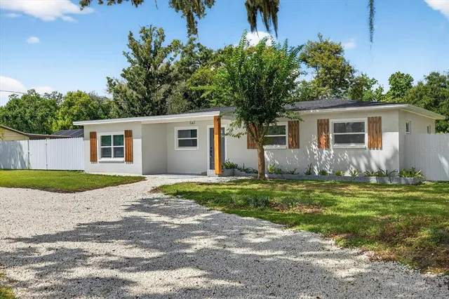 a view of a park with bench and trees