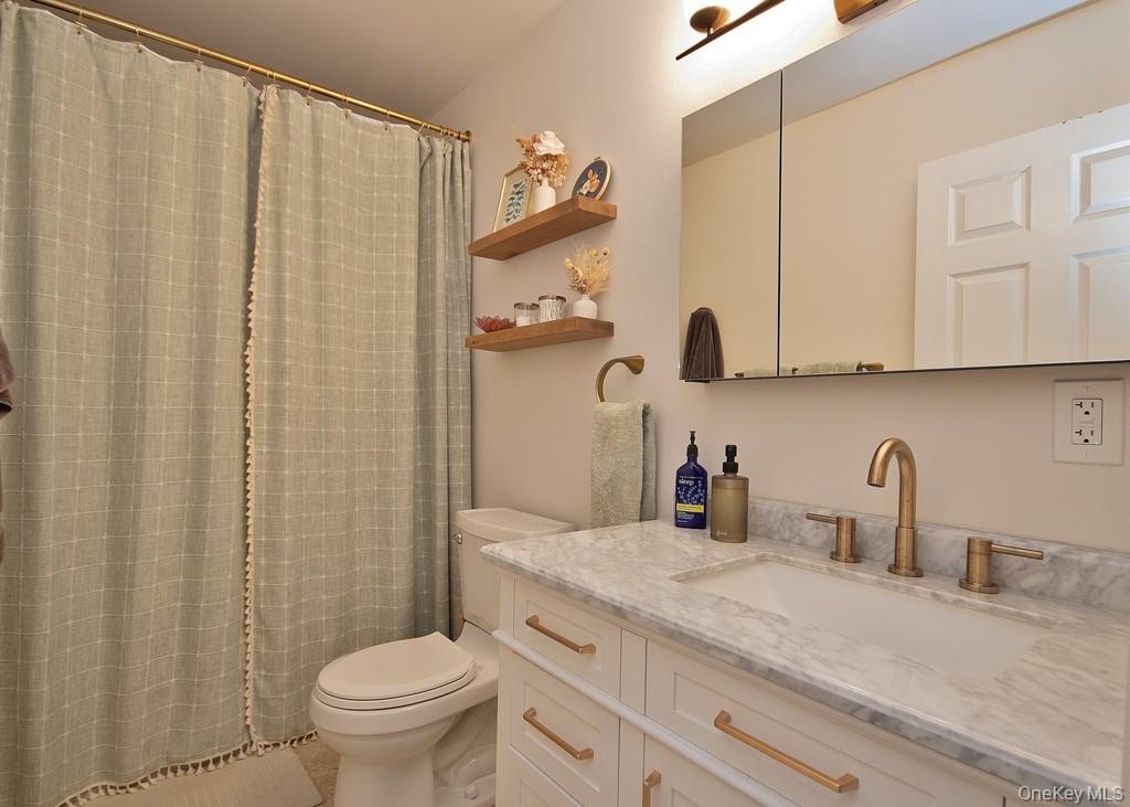 104 Mallard Way Peekskill, NY 10566 - Photo 14 of 26 Updated Primary Bathroom featuring mirrored medicine chest and sink with vanity